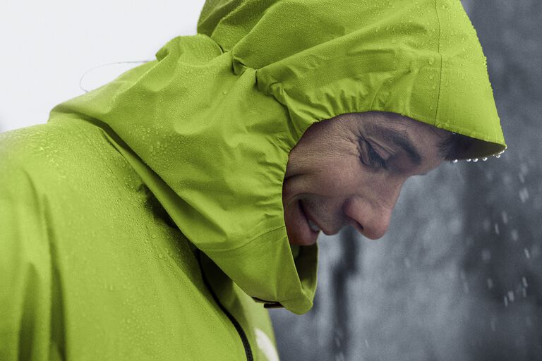The North Face athlete, Alex Honnold, wearing a green rain jacket.